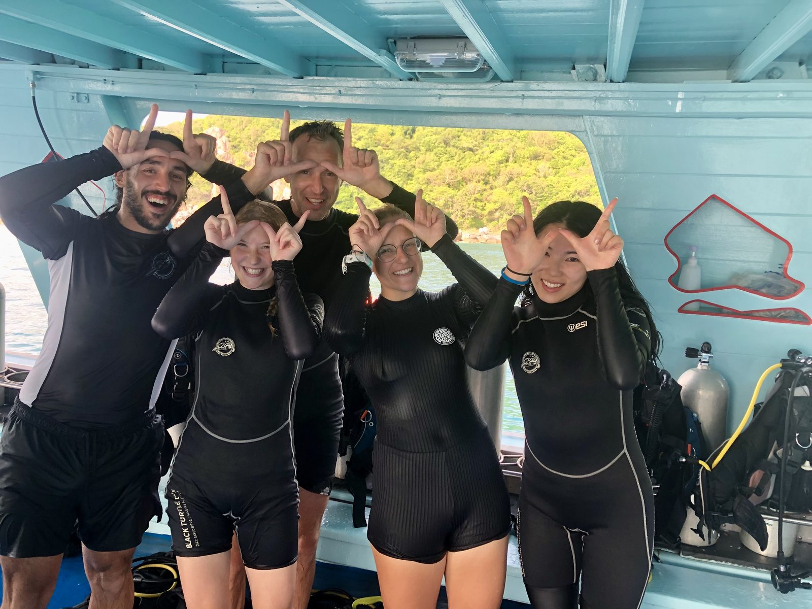 Danlin Zeng with dive buddies on the boat before a dive