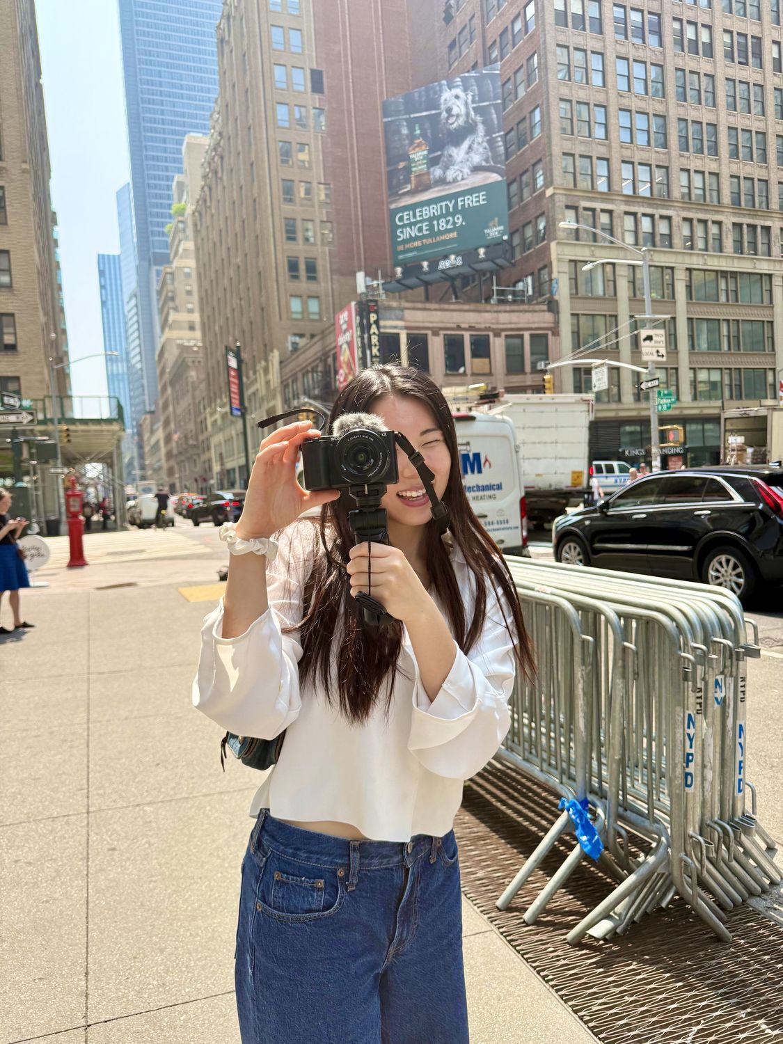 Danlin Zeng photographing on a New York street