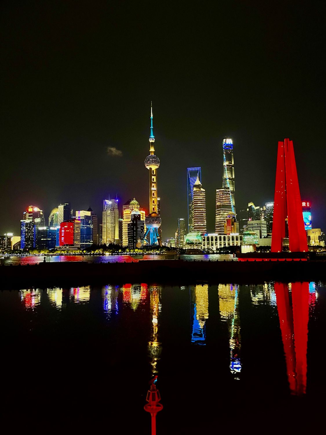 Pudong skyline at night reflected in the Huangpu River