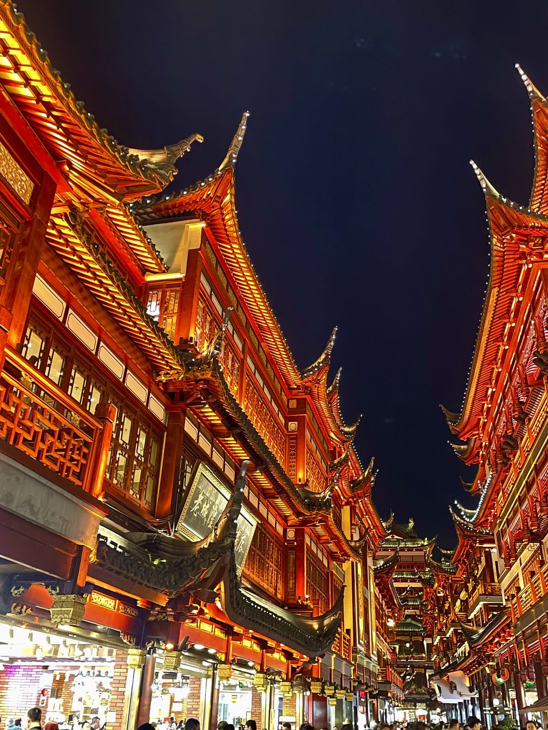 Illuminated upswept eaves of traditional Chinese architecture at night