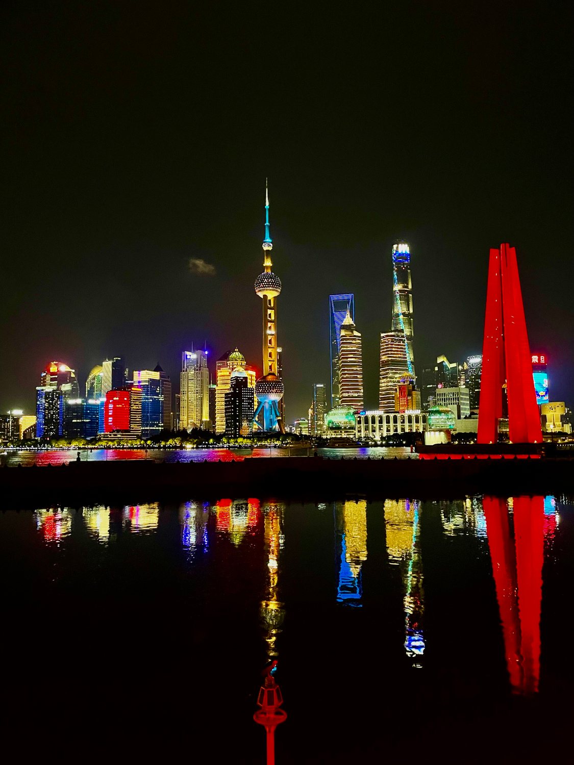 Pudong skyline at night reflected in the Huangpu River